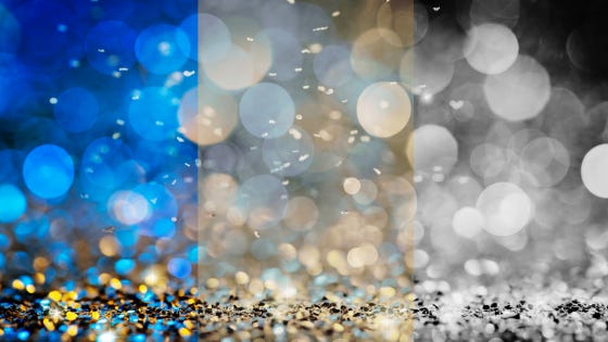 Blue and gold confetti dances among the lights...and slowly fades to grayscale across the page.