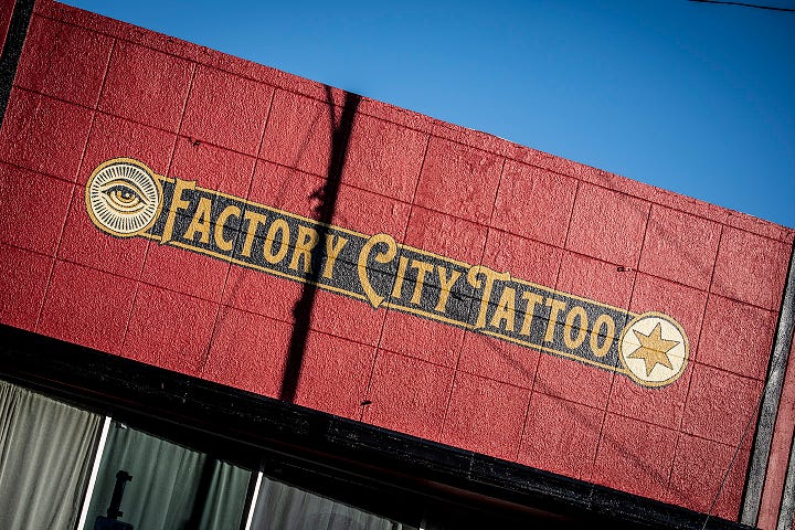 images of the outside of Factory City Tattoo, a red cinder block building
