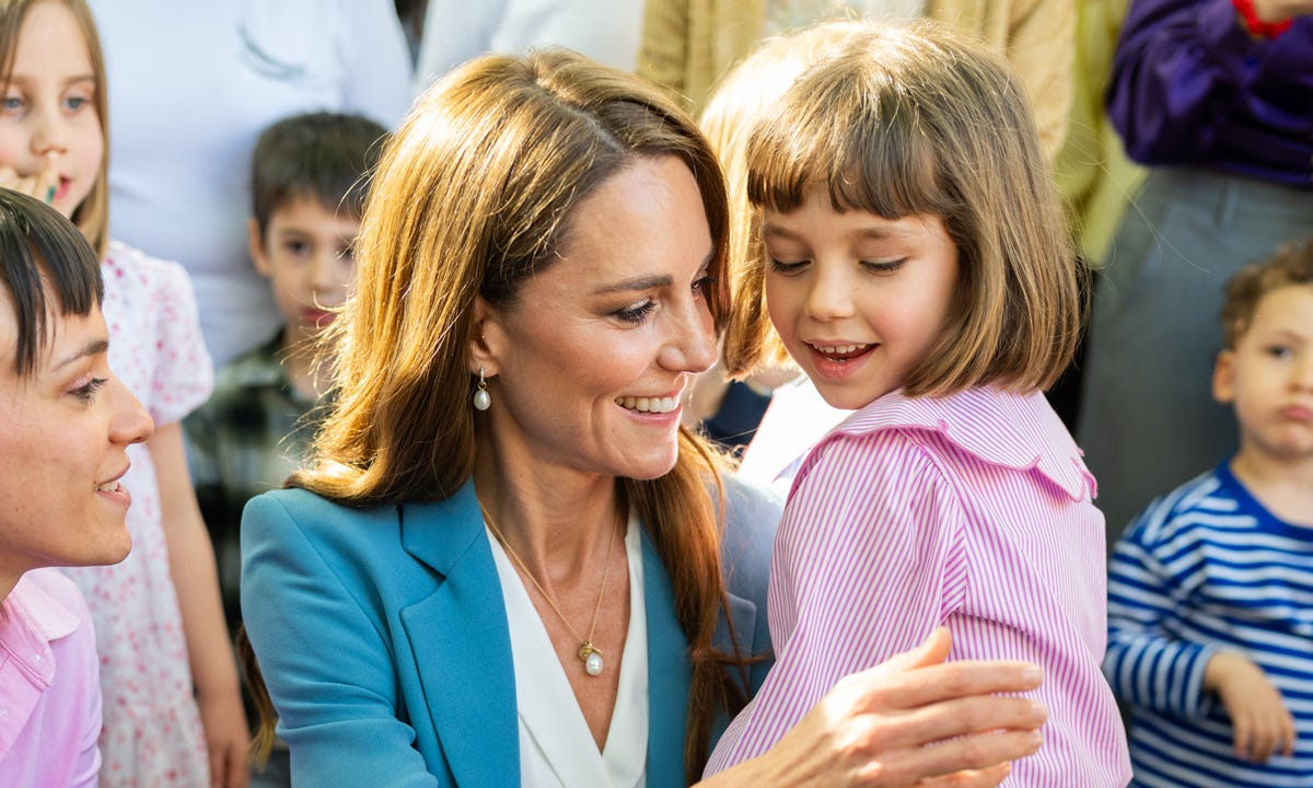 Princess Catherine hugging a young girl