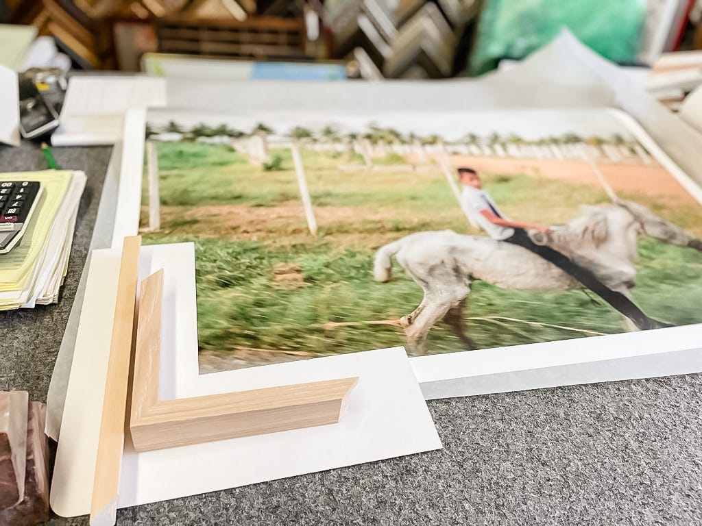 Photo of a photograph being prepared for framing at an art framing store