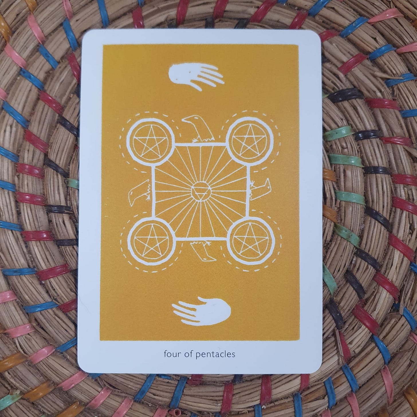 Alt text: Four of Pentacles tarot card from the Queer Crow Death Magic Tarot by Frank Duffy, photographed during Lucy Rose’s Tarot DMs interview as she discusses scarcity, stability, creative control, and the risks of leaving full-time work to pursue life as a freelance writer after the success of her novel The Lamb.