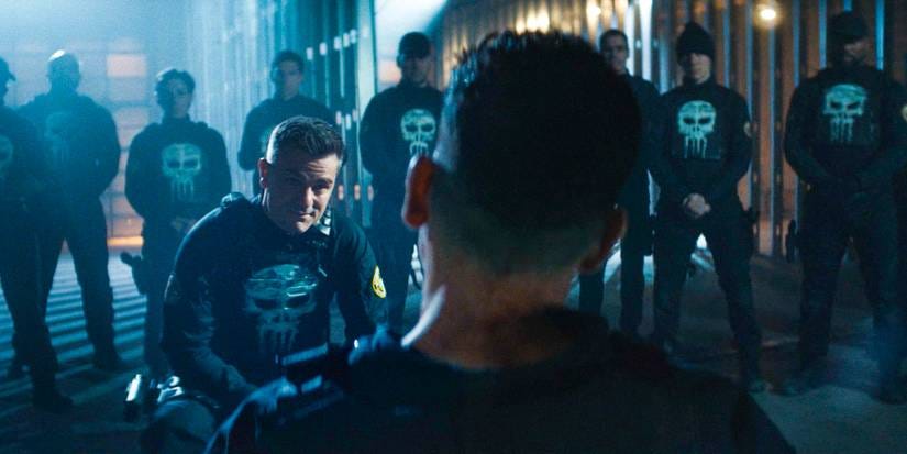 Frank Castle / Punisher is captured by the Anti-Vigilante Task Force, wearing Punisher-logo vests in Daredevil: Born Again Season 1 Ep 9