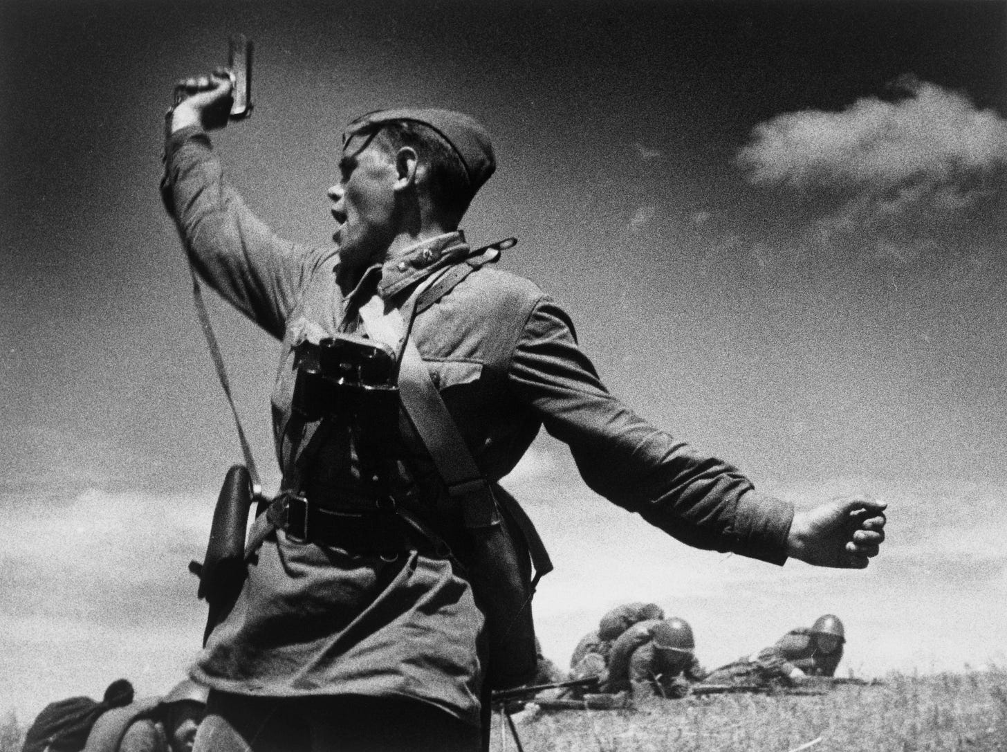 A Soviet junior political officer (Politruk) urges troops forward against German positions, July 12, 1942.