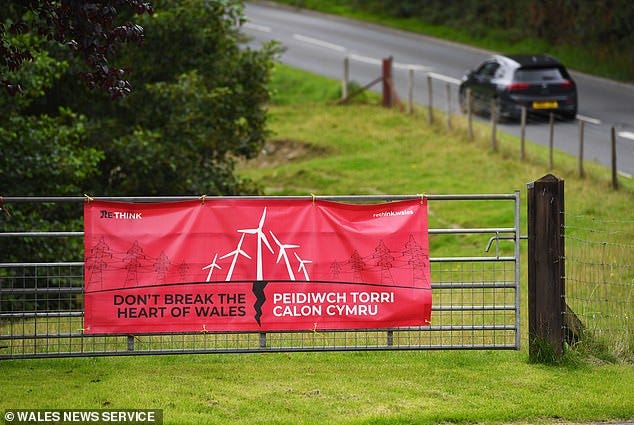 The turbines are 700ft and some would sit on hills 350ft high. Signs opposing their development dot the local area