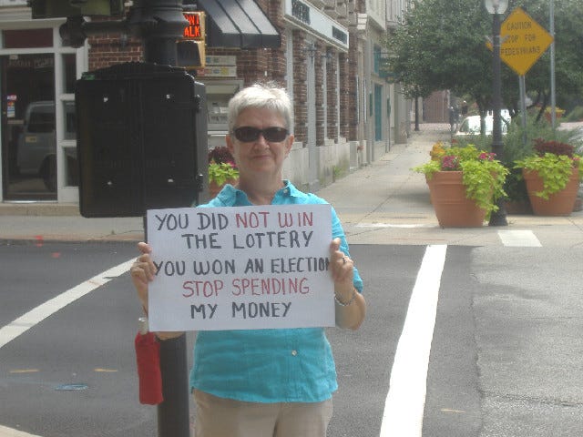 I didn't like the idea of one-sided 'I am AFP' signs but this woman took advantage to write her own message. We'll see if Frank Kratovil is rich like a lottery winner after his time in Congress is over. I didn't like the idea of one-sided 'I am AFP' signs but this woman took advantage to write her own message. We'll see if Frank Kratovil is rich like a lottery winner after his time in Congress is over.