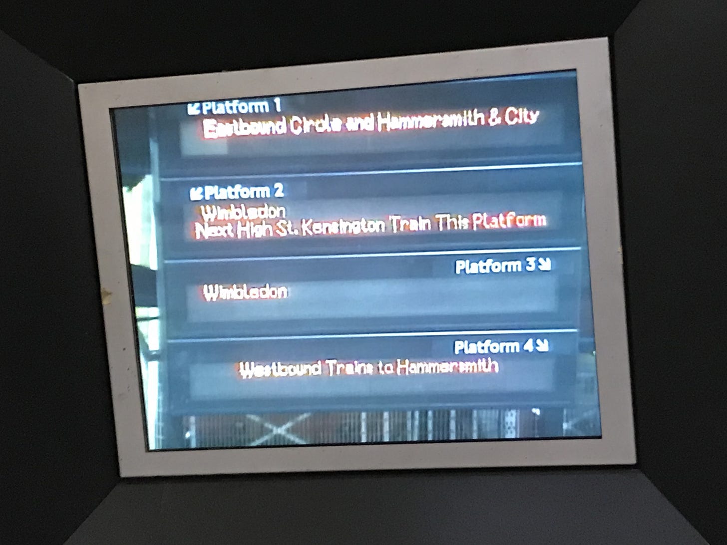 Photo of a screen showing camera feed of next train screens. Photo of a screen showing camera feed of next train screens.