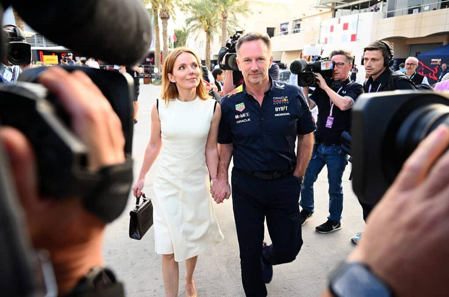 BAHRAIN, BAHRAIN - MARCH 02: Oracle Red Bull Racing Team Principal Christian Horner and Geri Horner walk in the Paddock holding hands prior to the F1 Grand Prix of Bahrain at Bahrain International Circuit on March 02, 2024 in Bahrain, Bahrain. (Photo by Clive Mason/Getty Images) BAHRAIN, BAHRAIN - MARCH 02: Oracle Red Bull Racing Team Principal Christian Horner and Geri Horner walk in the Paddock holding hands prior to the F1 Grand Prix of Bahrain at Bahrain International Circuit on March 02, 2024 in Bahrain, Bahrain. (Photo by Clive Mason/Getty Images)