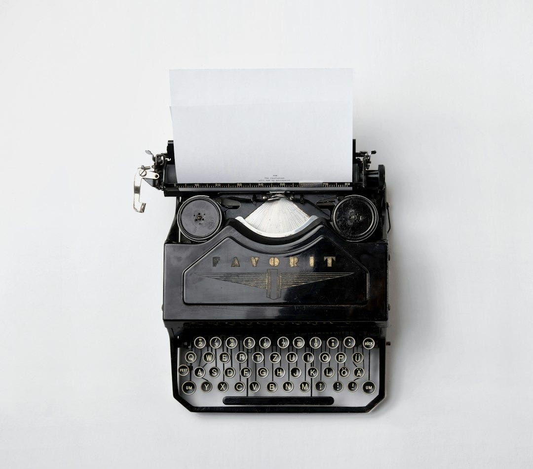 black Fayorit typewriter with printer paper