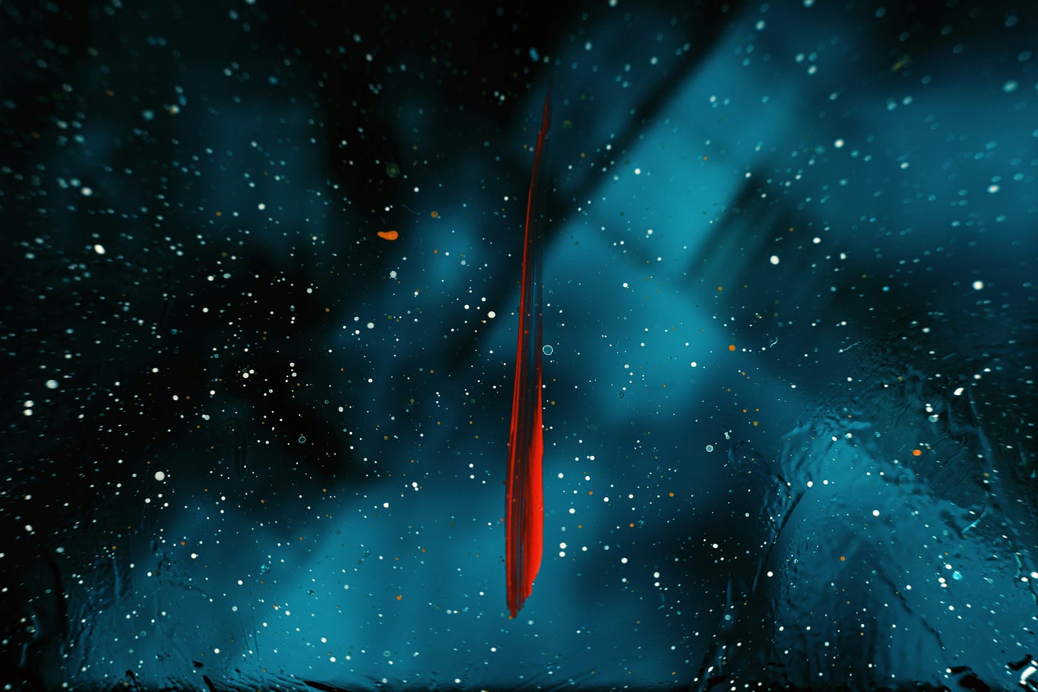 A streak of red on a blue and black background.