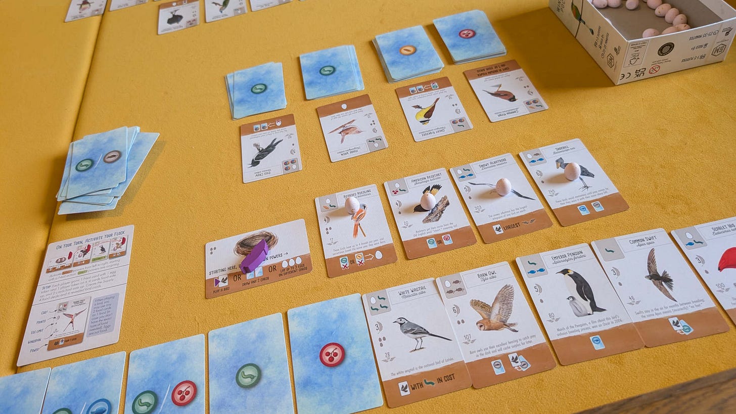 Some cards showing birds and food types laid out on a yellow felted play surface