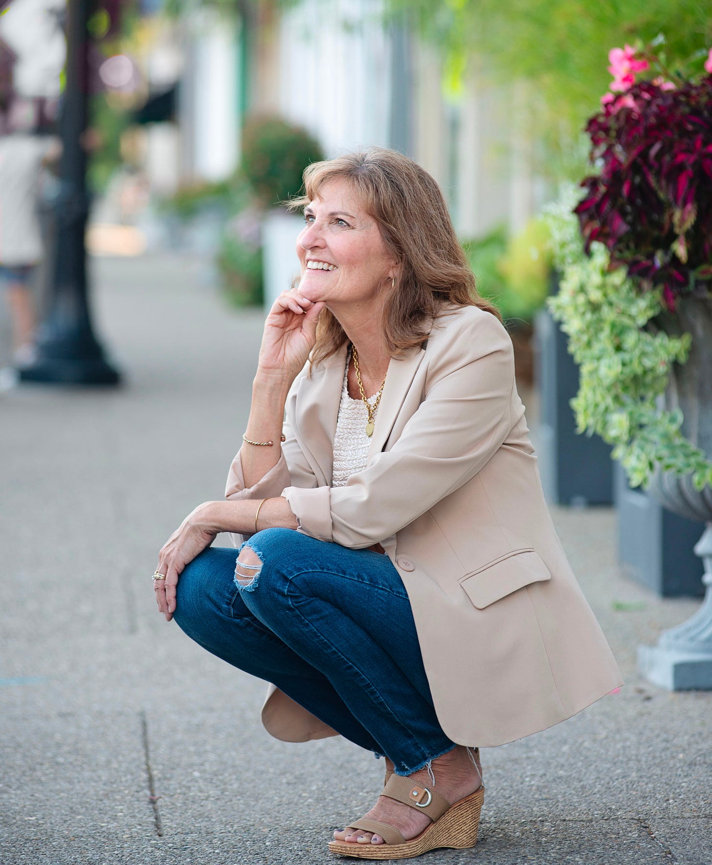 Author squatting looking off into sky