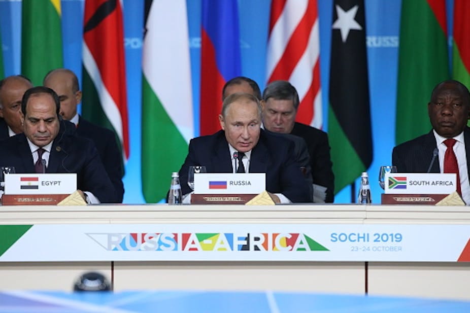 Three male presidents wearing ties address a press conference behind a desk with the sign Russia-Africa, Sochi 2019. Three male presidents wearing ties address a press conference behind a desk with the sign Russia-Africa, Sochi 2019.