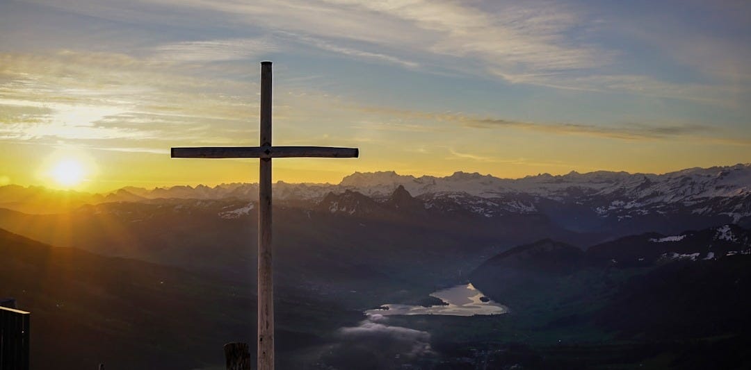 brown cross on mountain brown cross on mountain