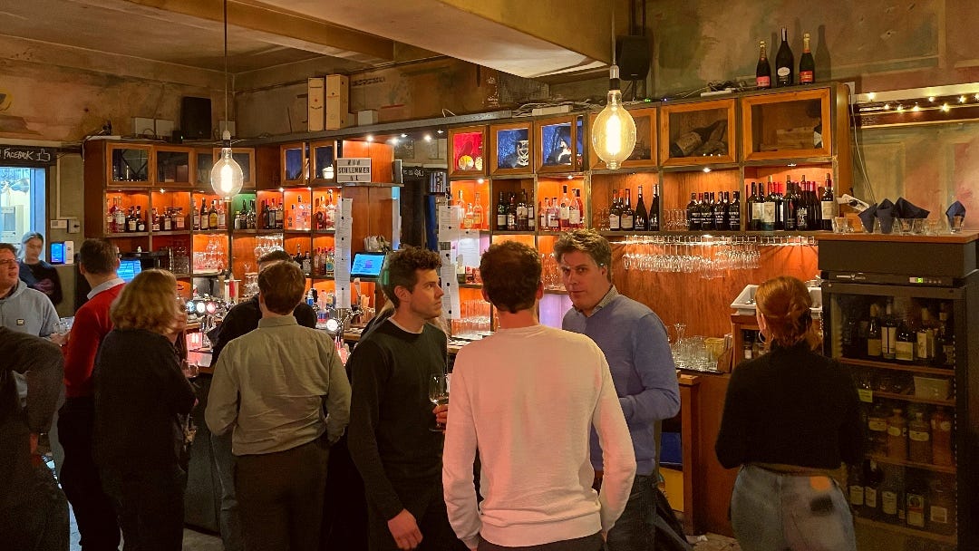 inside the cafe, people drinking beer