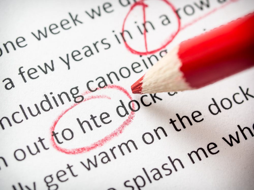 Red pencil correcting written copy on a page