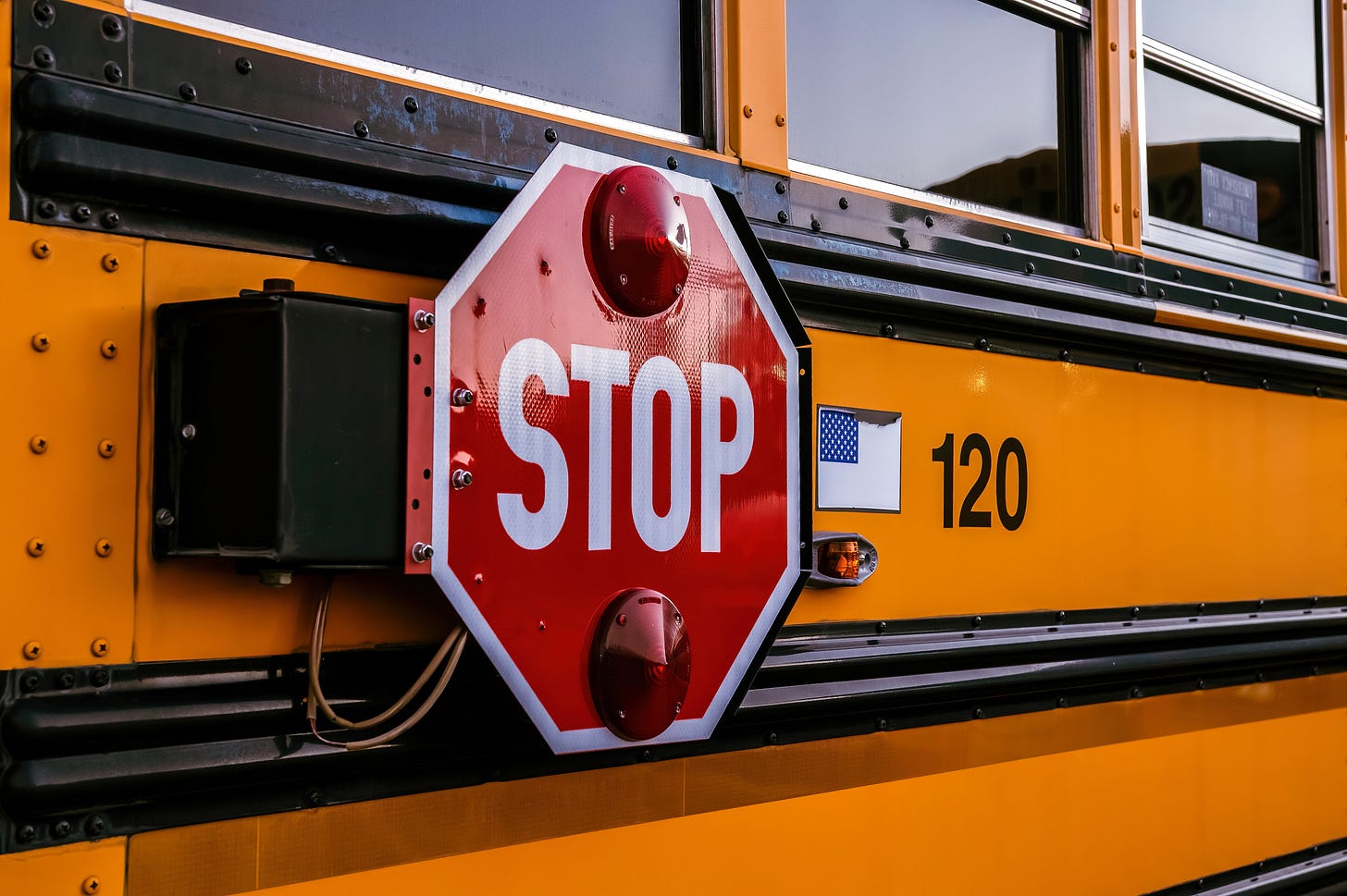 close up of yellow school bus red's stop sign close up of yellow school bus red's stop sign