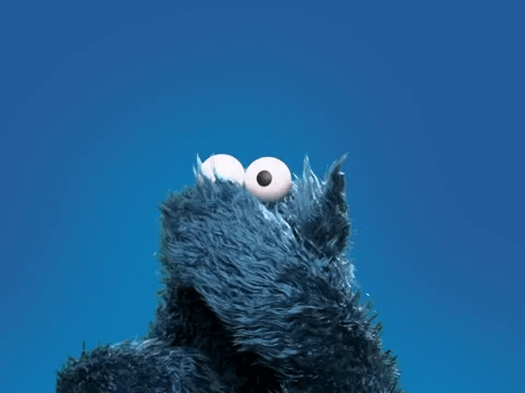 A blue puppet called cookie monster blows a kiss. A blue puppet called cookie monster blows a kiss.
