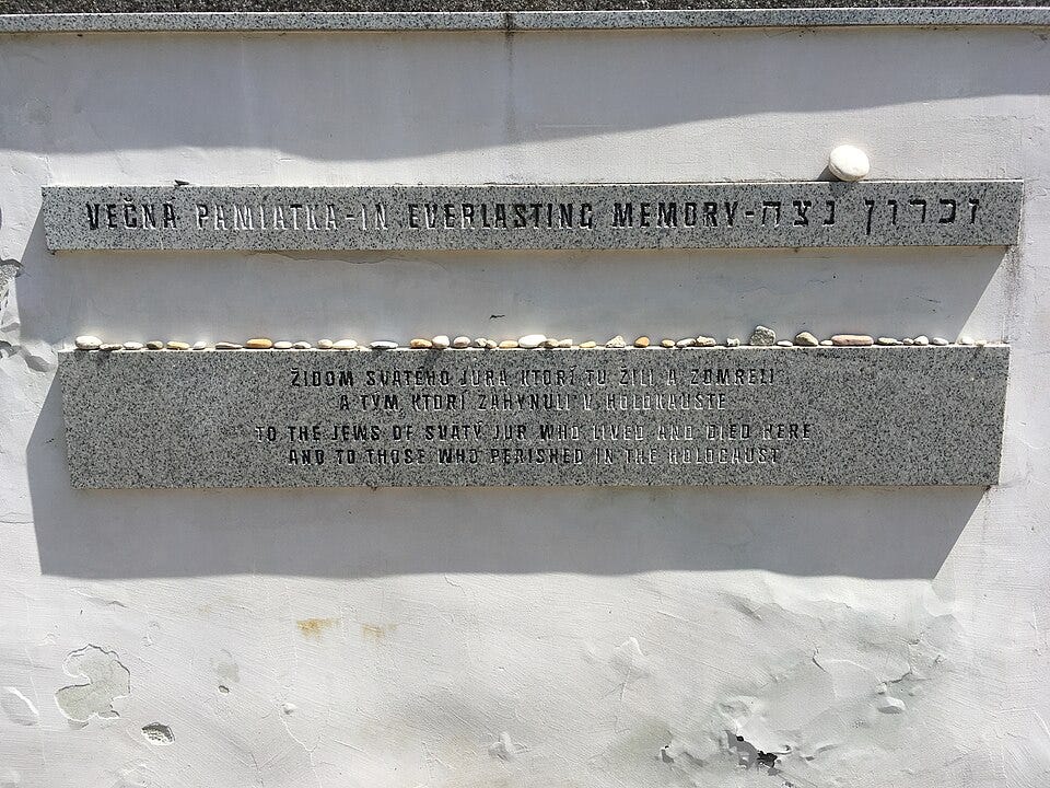Image of stone memorial with stones placed by visitors in remembrance