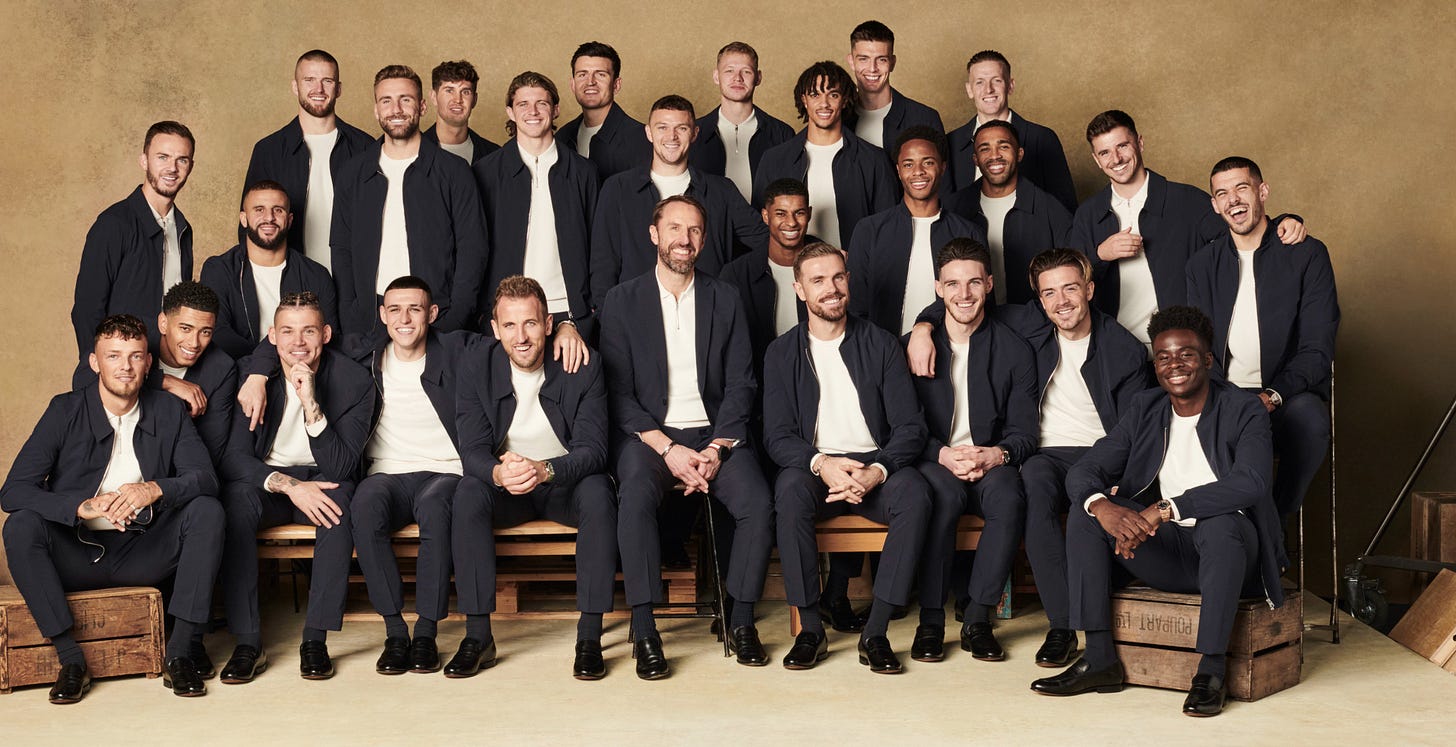 A squad photo of the England football team.

Top row: 

Eric Dier
John Stones 
Luke Shaw 
Conor Gallagher
Harry Maguire
Aaron Ramsdale
Trent Alexander-Arnold 
Nick Pope 
Jordan Pickford 
Mason Mount 

Middle row: 

James Maddison 
Kyle Walker 
Kieran Trippier 
Marcus Rashford 
Callum Wilson 
Raheem Sterling 
Conor Coady 

Front row: 
Ben White 
Jude Bellingham 
Kalvin Phillips 
Phil Foden 
Harry Kane 
Gareth Southgate
Jordan Henderson
Declan Rice
Jack Grealish 
Bukayo Saka 