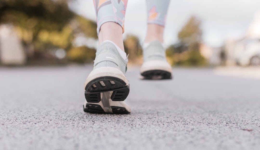 person in white and black nike shoes