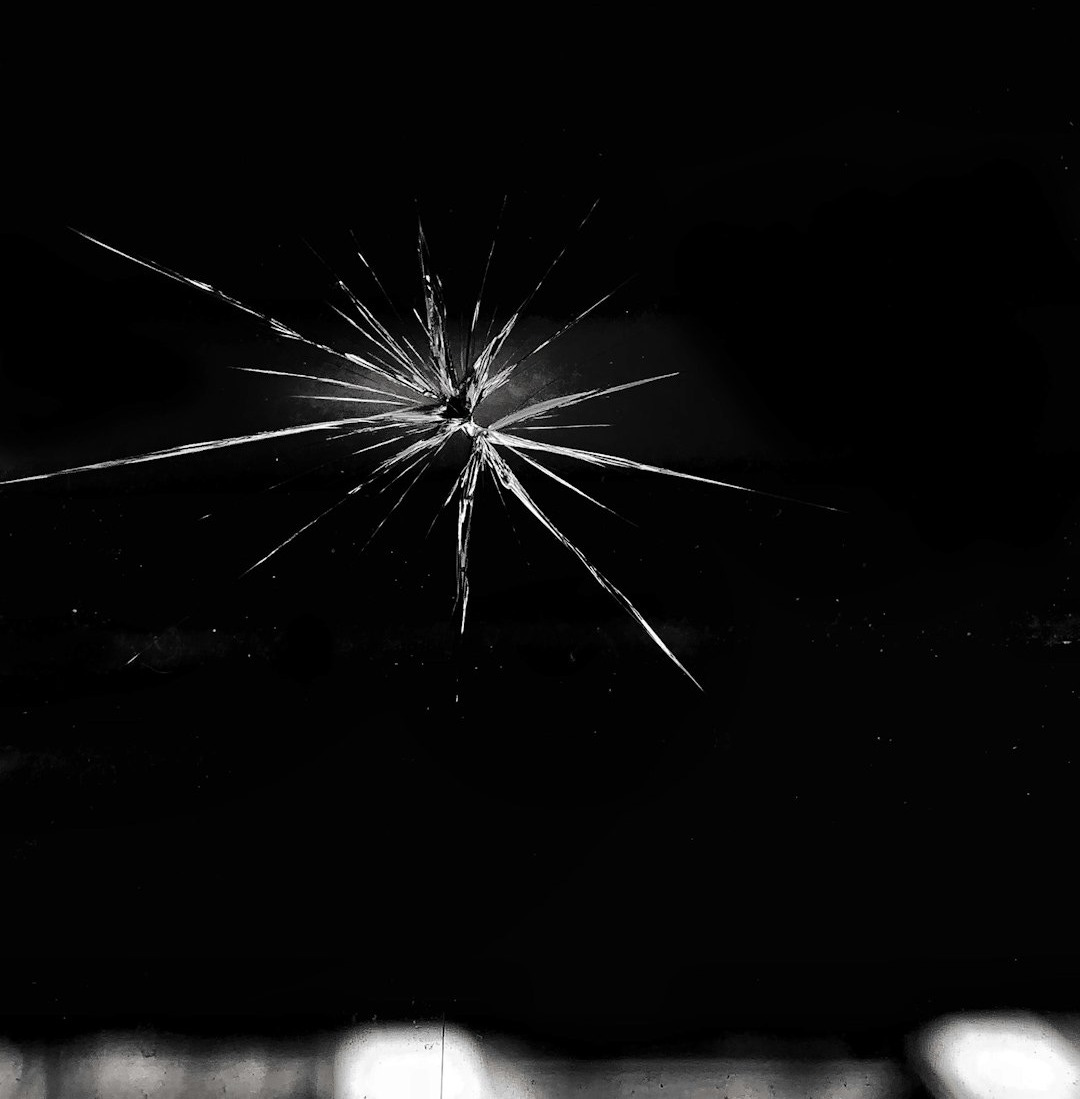 a black and white photo of a broken cell phone