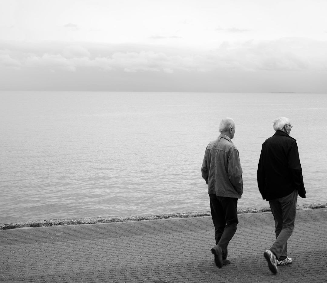 man and woman standing on seashore man and woman standing on seashore