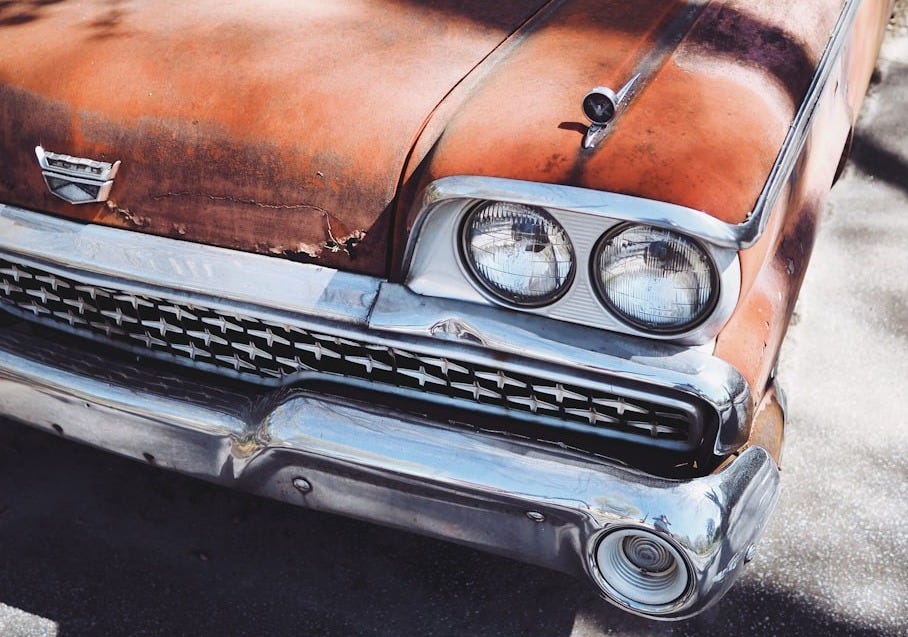 vintage orange car during daytime vintage orange car during daytime