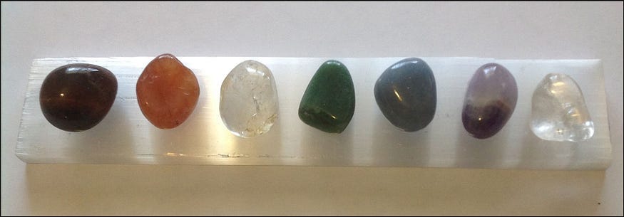 Seven crystals for the seven major chakras, on a selenite slab Seven crystals for the seven major chakras, on a selenite slab