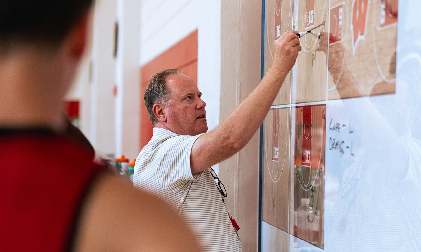 Wisconsin Badgers head coach Greg Gard draws a play on a whiteboard during practice inside the team's basketball practice facility. Wisconsin Badgers head coach Greg Gard draws a play on a whiteboard during practice inside the team's basketball practice facility.