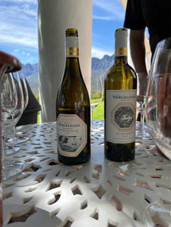 A couple of wine bottles on a table

Description automatically generated
