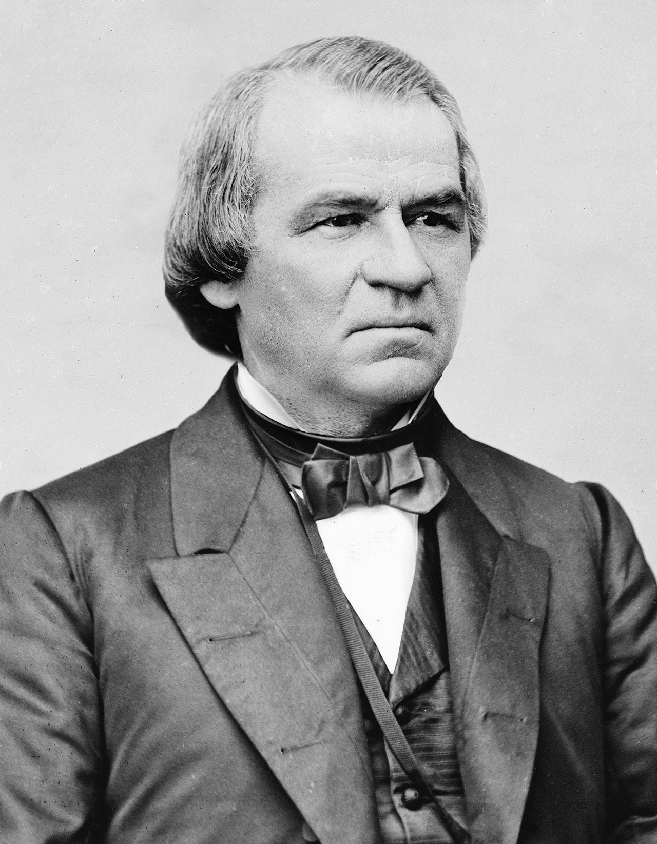 black and white portrait of andrew johnson, in suit squinting black and white portrait of andrew johnson, in suit squinting