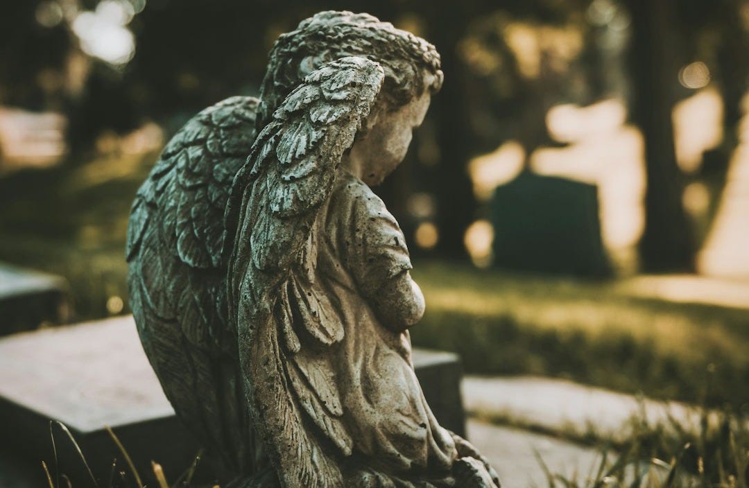 gray concrete statue of a woman