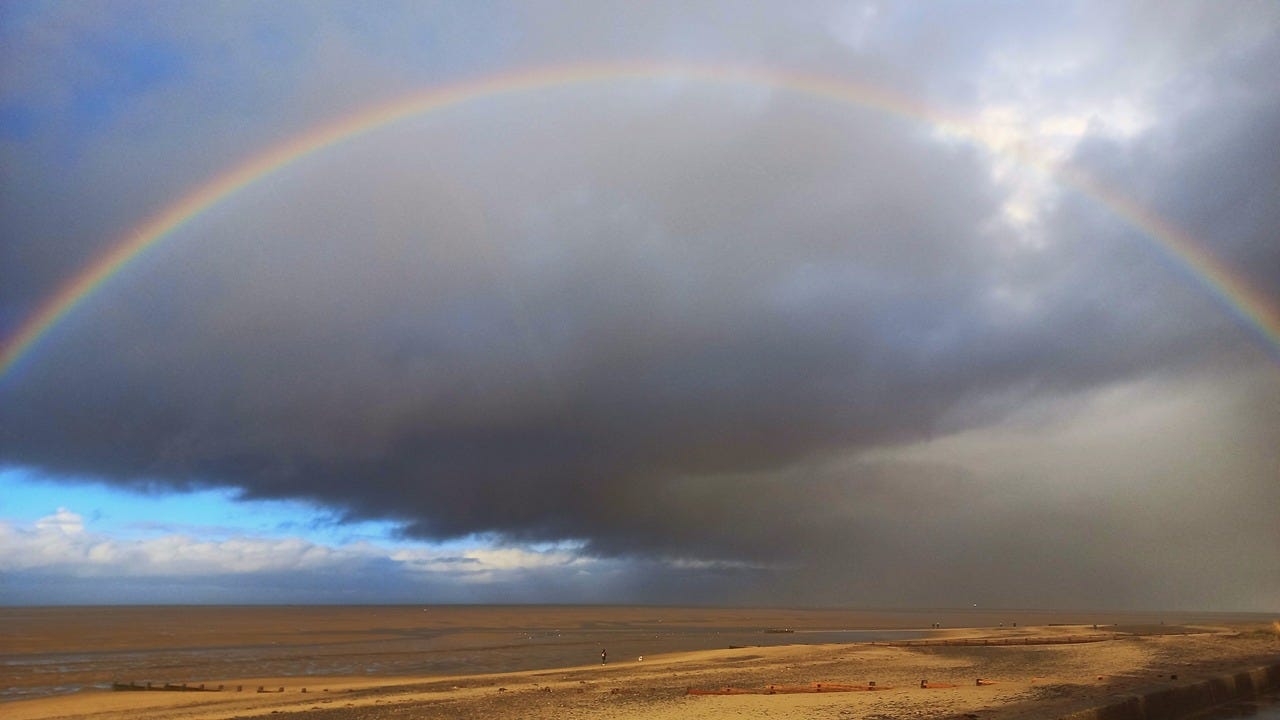 Rainbow above the sand of Morecambe Bay