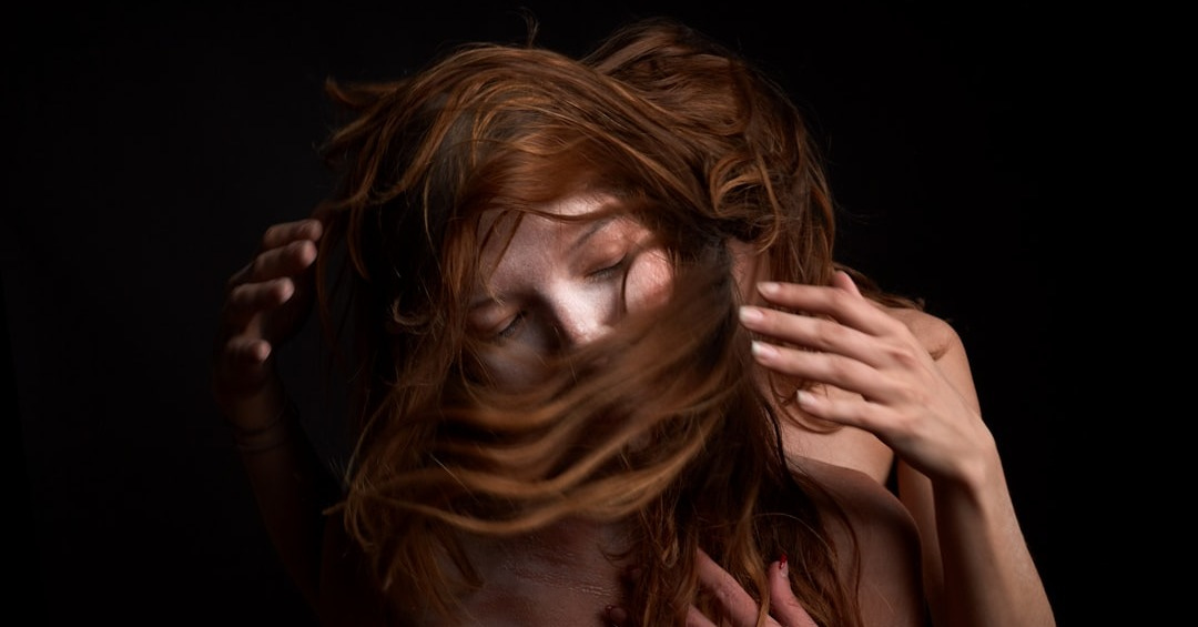 woman covering her face with her hands