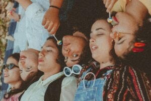 Girls lying on their backs in a row