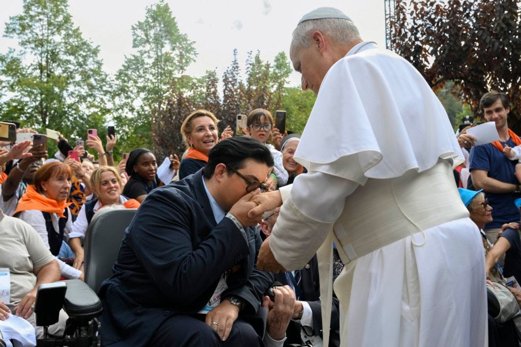 A man kisses the hand of Pope Leo XIV at Lourdes A man kisses the hand of Pope Leo XIV at Lourdes