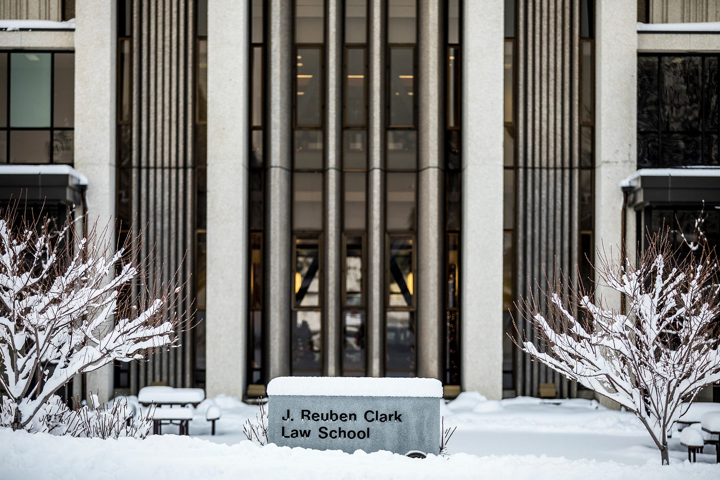 Exterior of the BYU Law School building covered in snow