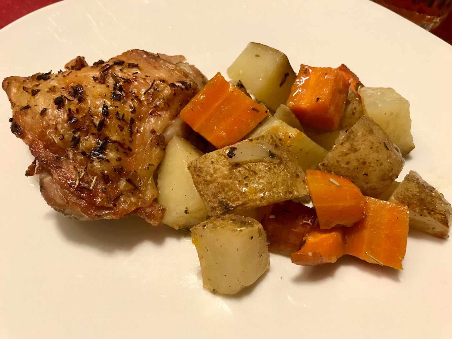 backed chicken thigh with potatoes and carrots 