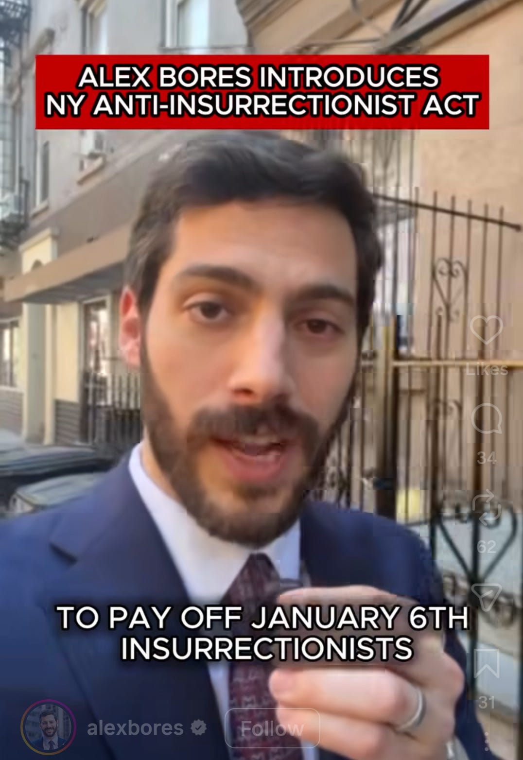 A shot from a video by Assemblyman Alex Bores. He is walking down a New York City street in a suit and talking into a mike. The header on it reads "Alex Bores Introduces NY ANti-Insurrectionists Act."