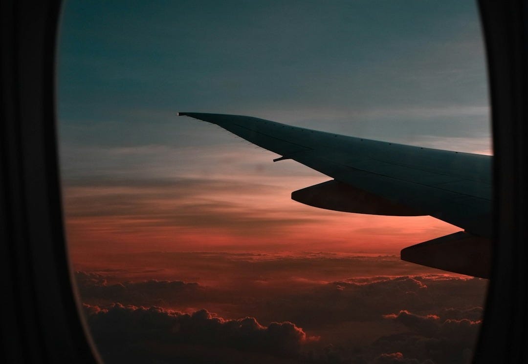 window view of airplane during golden hour