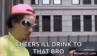 a man wearing sunglasses and a pink hat is standing in front of a building and talking . a man wearing sunglasses and a pink hat is standing in front of a building and talking .