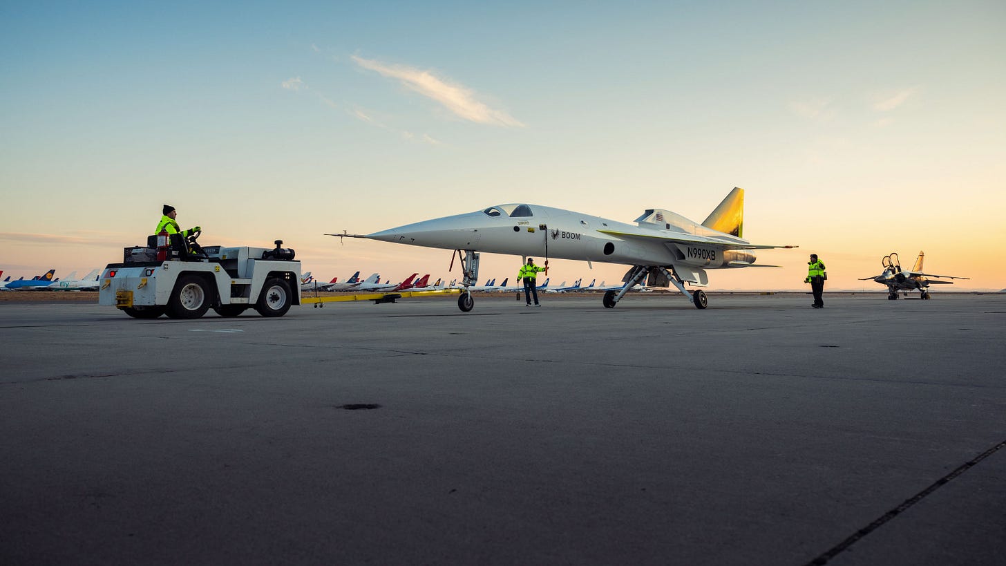 the Boom xB-1 on the tarmac at sunrise with a ground crew