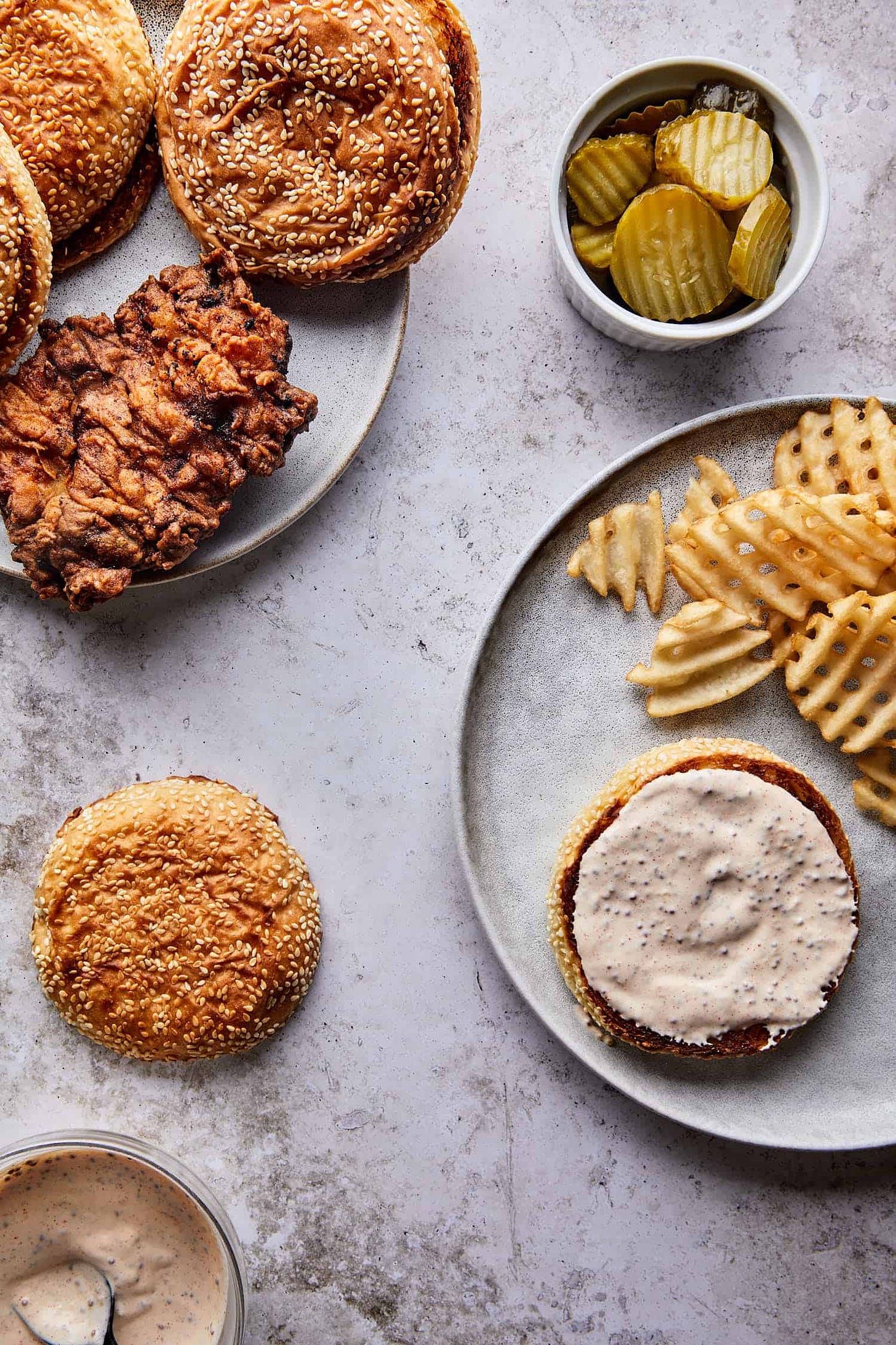 Toasted brioche buns with shredded lettuce and pickles, ready to build the best fried chicken sandwich recipe.
Toasted brioche buns with shredded lettuce and pickles, ready to build the best fried chicken sandwich recipe.