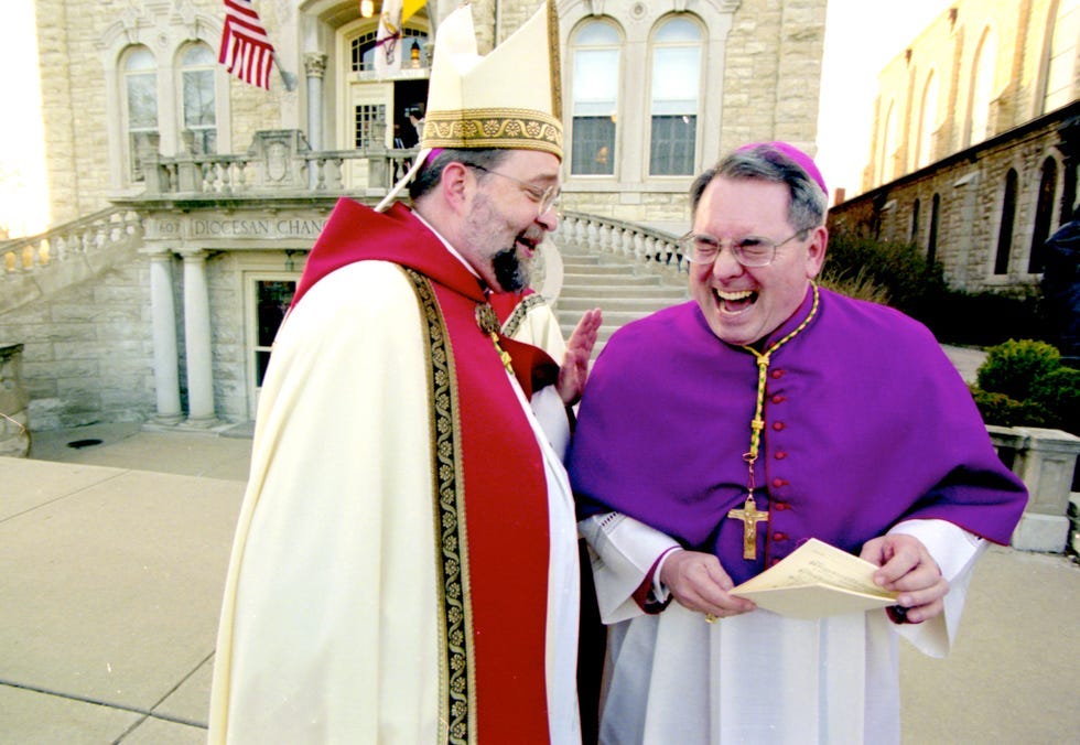 Bishop John J. Myers, left, and Bishop Daniel Jenky share a laugh during a prayer service on April 9, 2002 in Peoria.
