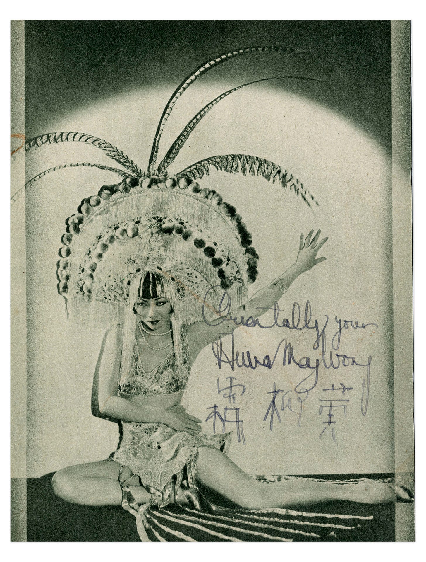 a black and white publicity photo autographed by Anna May Wong and signed with her catchphrase “Orientally Yours”