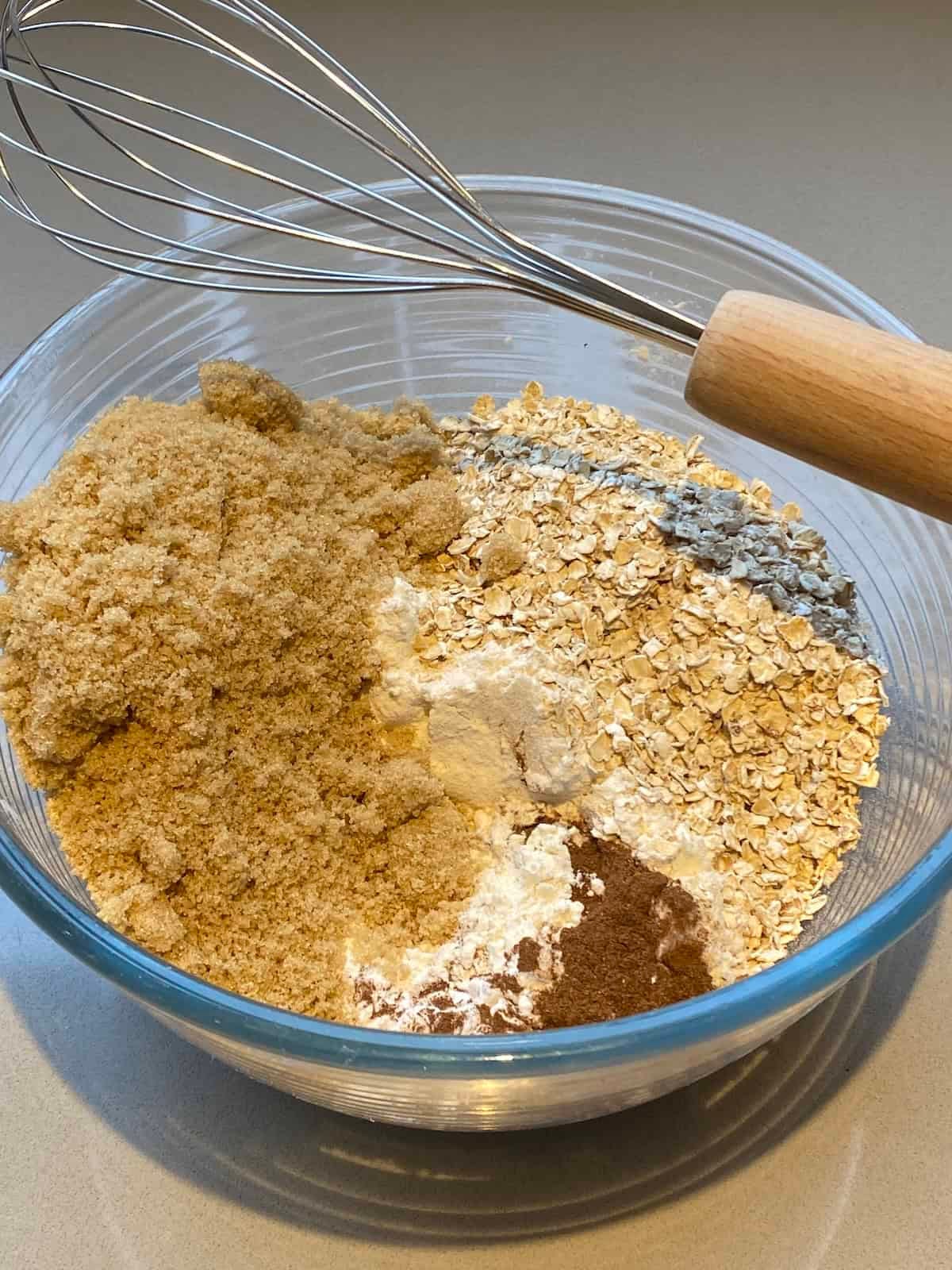 Ingredients for Apple, Oats and Cinnamon Muffins in a large mixing bowl. Ingredients for Apple, Oats and Cinnamon Muffins in a large mixing bowl.
