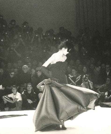 Top row, left to right: Yohji Yamamoto Fall/Winter 1983, Fall/Winter 2016, and an editorial look echoing his sculptural tailoring. Bottom row, left to right: Yamamoto in portrait (c. 1980s), Spring/Summer 1999 (wabi-sabi torn linen), and Spring/Summer 2023 (cage crinoline gown); Together, these works reflect Yamamoto’s enduring focus on asymmetry, restraint, and the poetic tension between structure and decay.