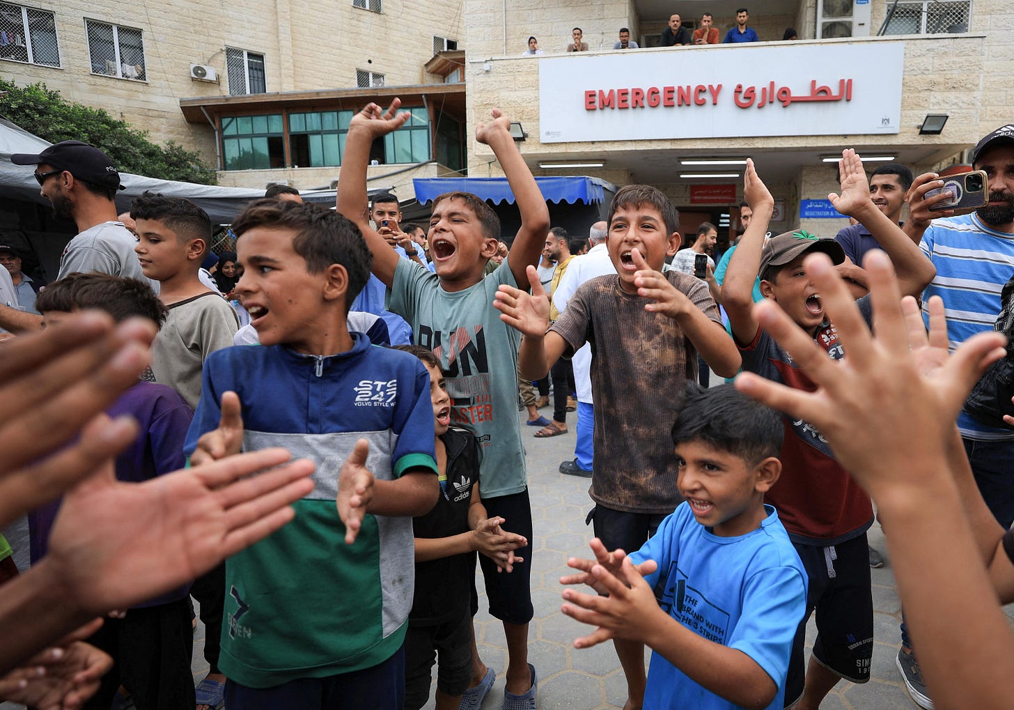 Palestinian children celebrate, after U.S. President Donald Trump announced that Israel and Hamas agreed on the first phase of a Gaza ceasefire, at Al-Aqsa Martyrs Hospital, in Deir al-Balah, in the central Gaza Strip, October 9, 2025. REUTERS