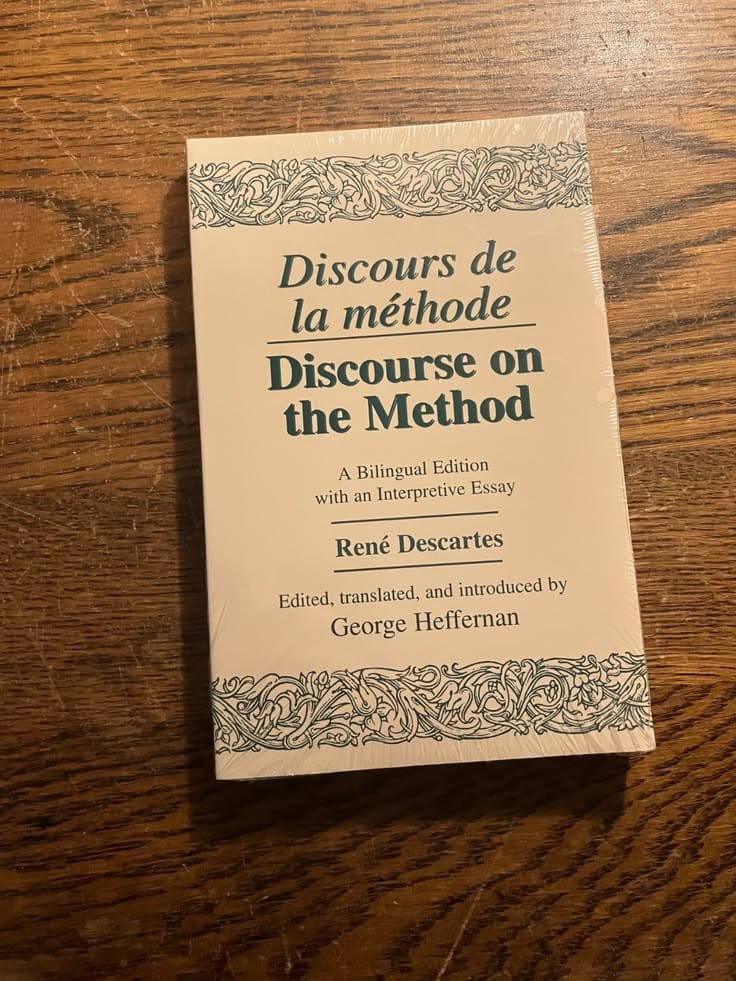 This may contain: a book sitting on top of a wooden table