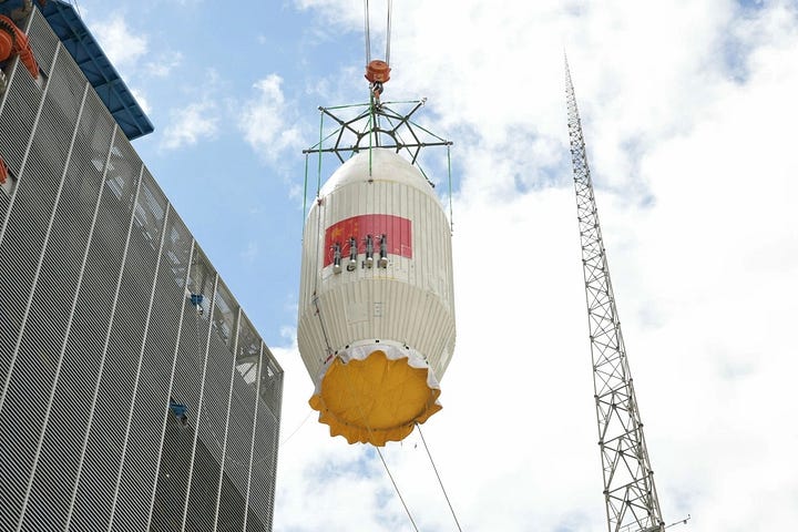 The Long March 4C's first-stage being prepared for the flight, its fairing heading to the launch pad, and it's third-stage and fairing being lifted onto the vehicle.